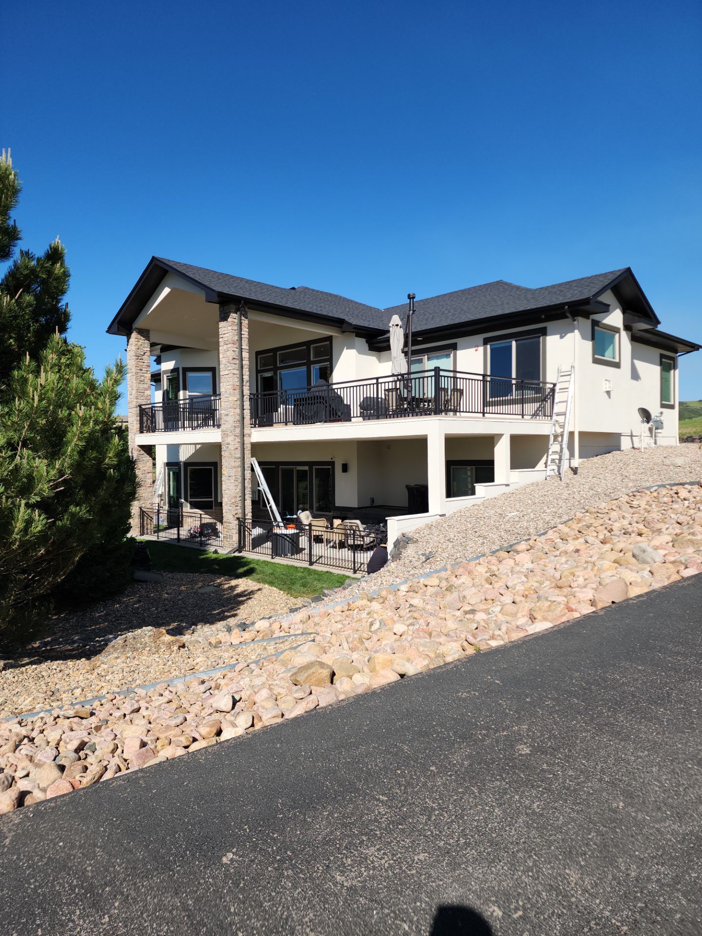 Castle Rock Elegance: White Stucco Exterior with Bold Tricorn Black